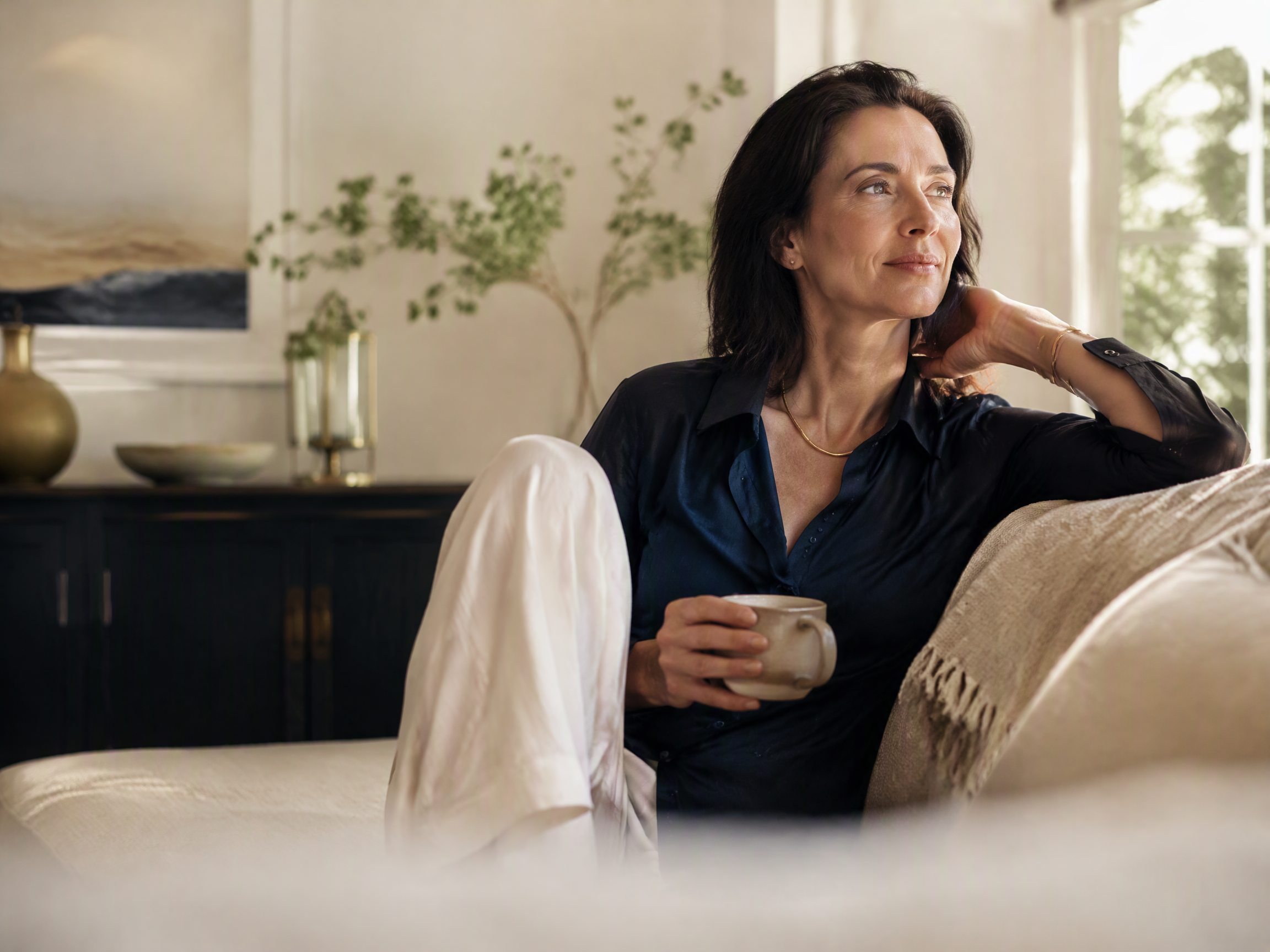 Adult woman relaxing in a calm, naturally lit home setting